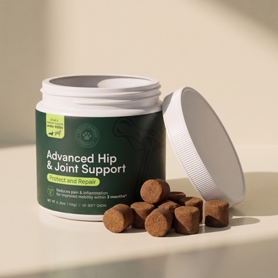 An open tub of Barkwell Advanced Hip and Joint Support with the lid resting beside it and soft chews in front